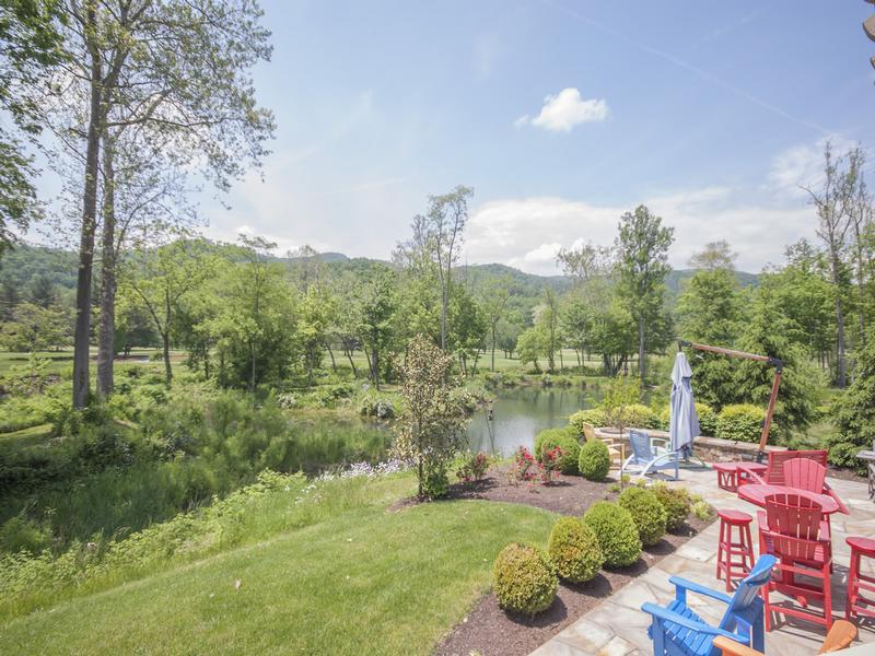 A back yard meant for patio gatherings around the firepit