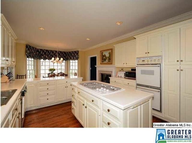 Large eat-in kitchen with fireplace, tons of natural light and lake view.