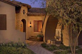 The approach to a Club Village home reflects the craftsmanship that embraces Arizona�s early territorial traits of wood, stone and stucco.