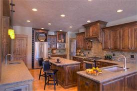 Spacious gourmet Kitchen includes a preparation island with breakfast bar, a freestanding wet bar plus handy pantry.