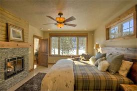 Extra spacious Master Bedroom showcases a cozy fireplace; Large picture windows add welcome natural light.