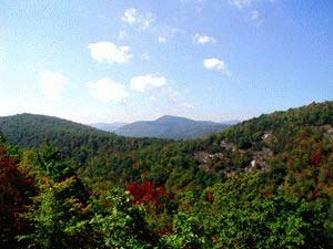 The Divide at Bald Rock - Cashiers (Sapphire), North Carolina - With altitudes topping 4,500 feet, The Divide at Bald Rock features amazing long range mountain views, lush foliage, cascading waterfalls, and extraordinary panoramas of sheer rock cliffs and sylvan valleys. All Divide property owners are members in the Sapphire Valley resort, and have access to numerous recreational amenities including an 18-hole championship mountain golf course, indoor/outdoor swimming pools, tennis center, exercise facilities, miniature golf, boat rentals on 55-acre Lake Fairfield and winter skiing. Large estate homesites priced from $159,000 to $550,000.