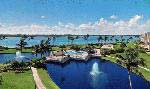 Wandering sidewalks amid a park-like setting overlook a quiet nature preserve beyond the shores of Jupiter Island.
