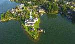Aerial view of custom home on the lake point at Hot Springs Village
