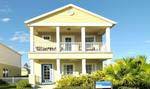 The Gull Cottage features a covered balcony off the master suite and a private fenced courtyard between the house and two-car garage.