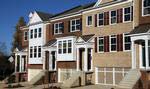 The Tyler by Pulte Homes features brick front exteriors, pillared front porticos and two car garages.