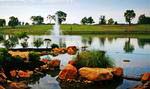 A view of the community’s 15-acre lake with lighted fountain and meandering river.