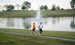 A lighted jogging/walking path with a rubberized surface winds around the main lake at Equestrian Lakes.