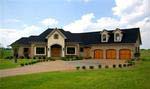 French Country-style model home located within Equestrian Lakes on a 5.46-acre lakefront lot.