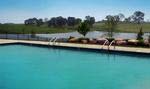 Residents of Equestrian Lakes enjoy scenic lake views from the sunning deck at the community’s pools.