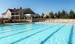 The outdoor Olympic sized swimming pool includes a separate kid’s play area.