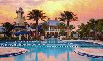 A view of the MiraBay Club and pool deck at sunset.