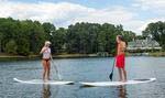 A couple paddleboarding on Lake Oconee.